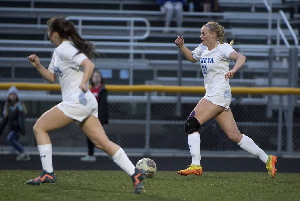 Geneva's Lilly Coats (21) moves the ball up the field against Bartlett during a nonconference game in Bartlett on Monday, April 3, 2023.