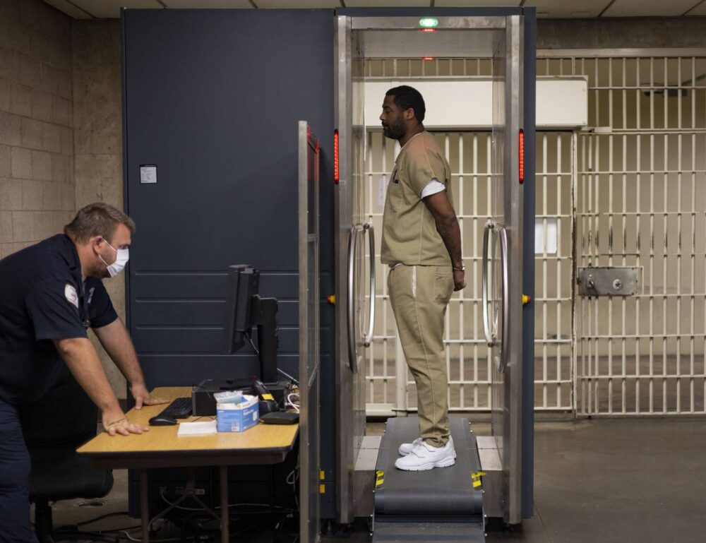Detainee Michael Laster goes through a security scan at Cook County Jail before heading to a court appearance in October 2022.