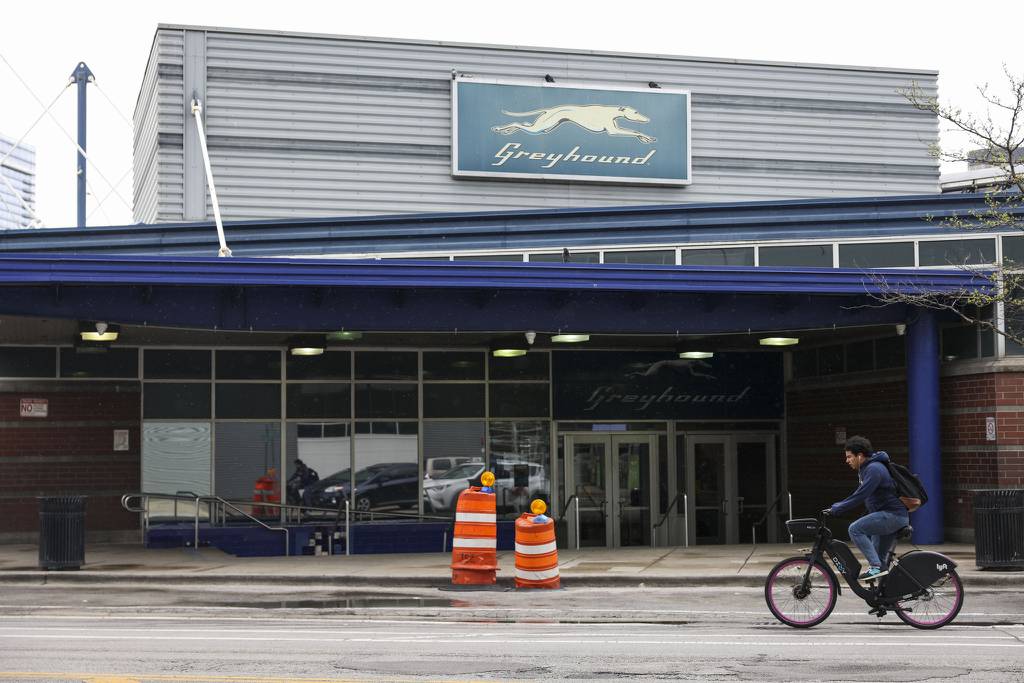 A cyclist rides past the Greyhound bus station in the Near West Side neighborhood on April 17, 2023. 