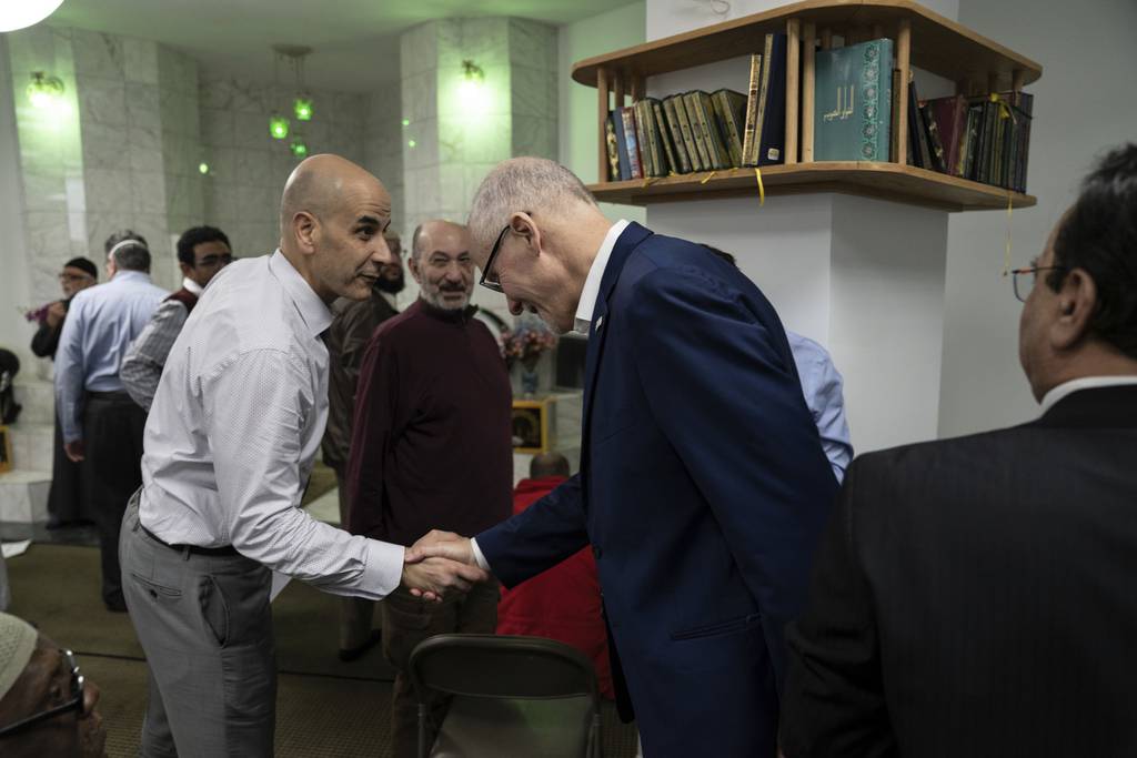 Mayoral candidate Paul Vallas, center, visits the Downtown Islamic Center during Ramadan Friday.