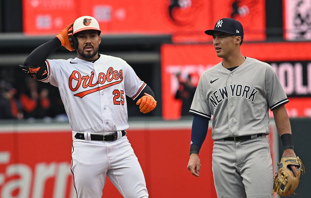 Orioles outfielder Anthony Santander, left, makes a gesture similar to the sprinkler dance at second base after a double in the third inning of Friday's home opener against the New York Yankees.