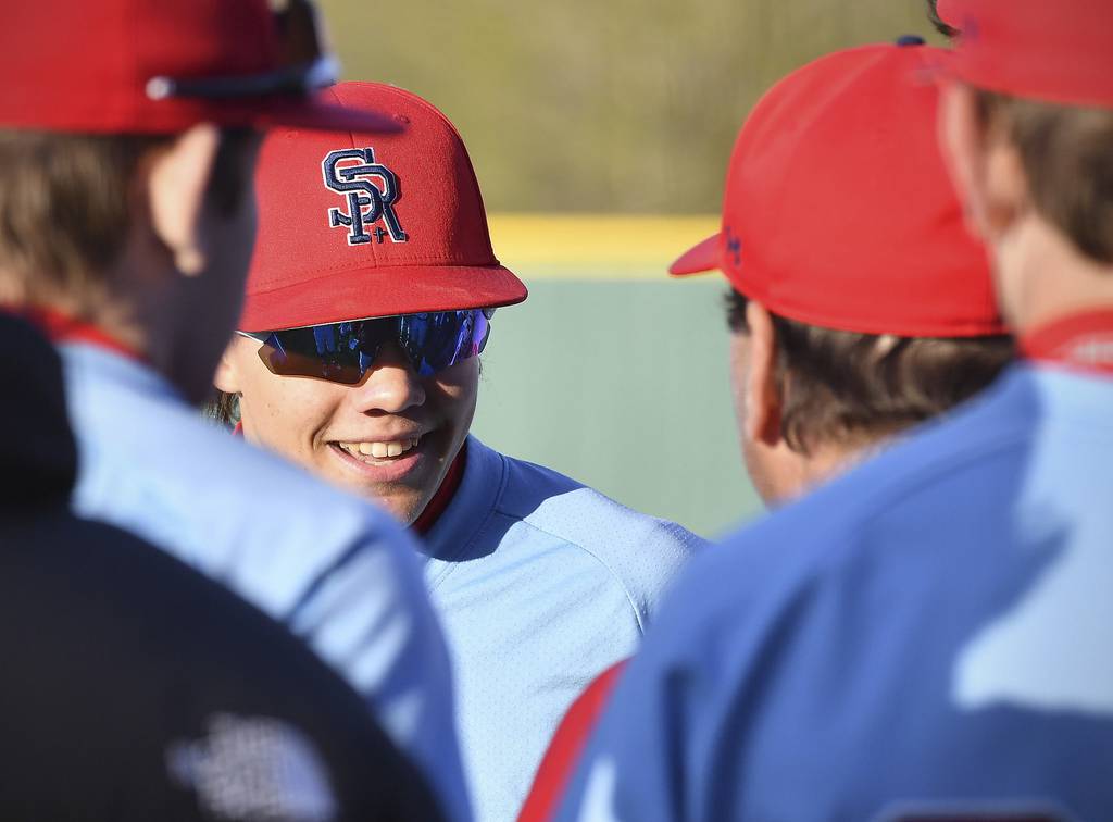 St. Rita's Tommy Atkinson is greeted by teammates as he returns to the dugout after retiring his brother Sammy, who plays for Providence, during a Catholic League Blue game in New Lenox on Tuesday, April 18, 2023.