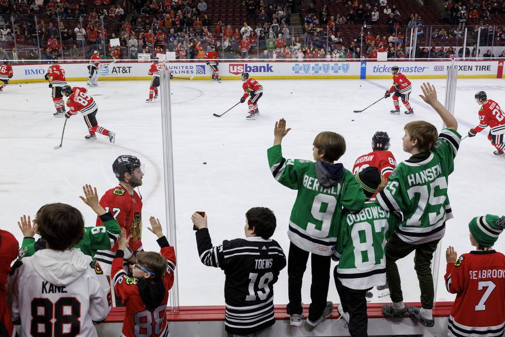 Fans watch the Blackhawks take the ice for warmups before the game against the Canucks at the United Center on March 26, 2023.