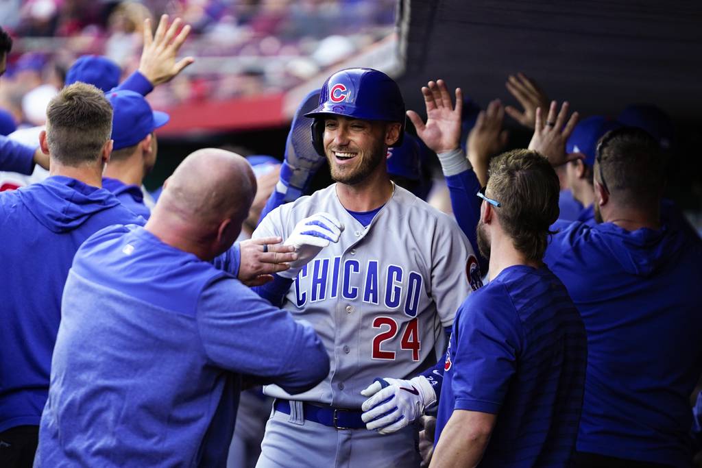 The Cubs' Cody Bellinger (24) celebrates with teammates after hitting a three-run home run against the Reds in the first inning Monday, April 3, 2023, in Cincinnati.