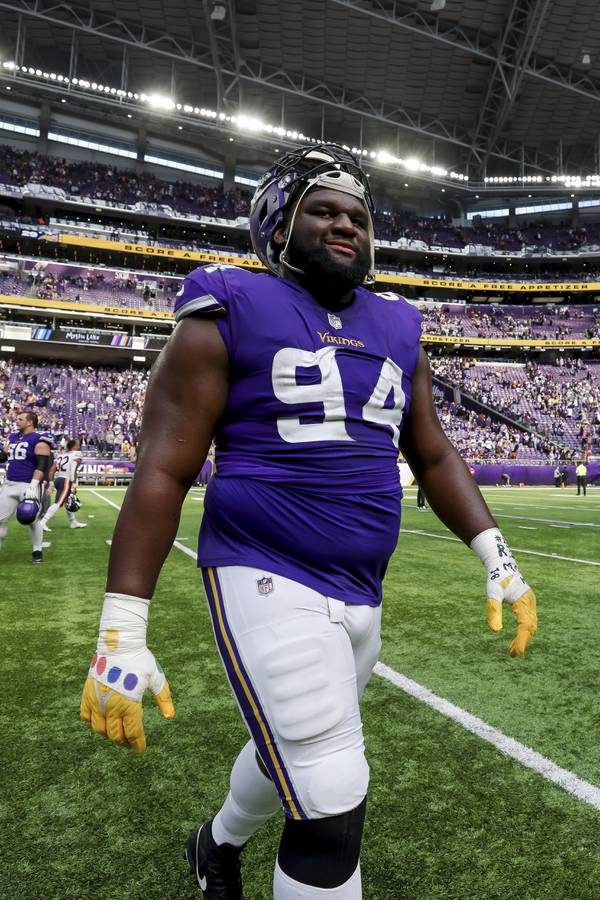 Vikings defensive tackle Dalvin Tomlinson walks on the field after a game against the Bears on Oct. 9, 2022, in Minneapolis.