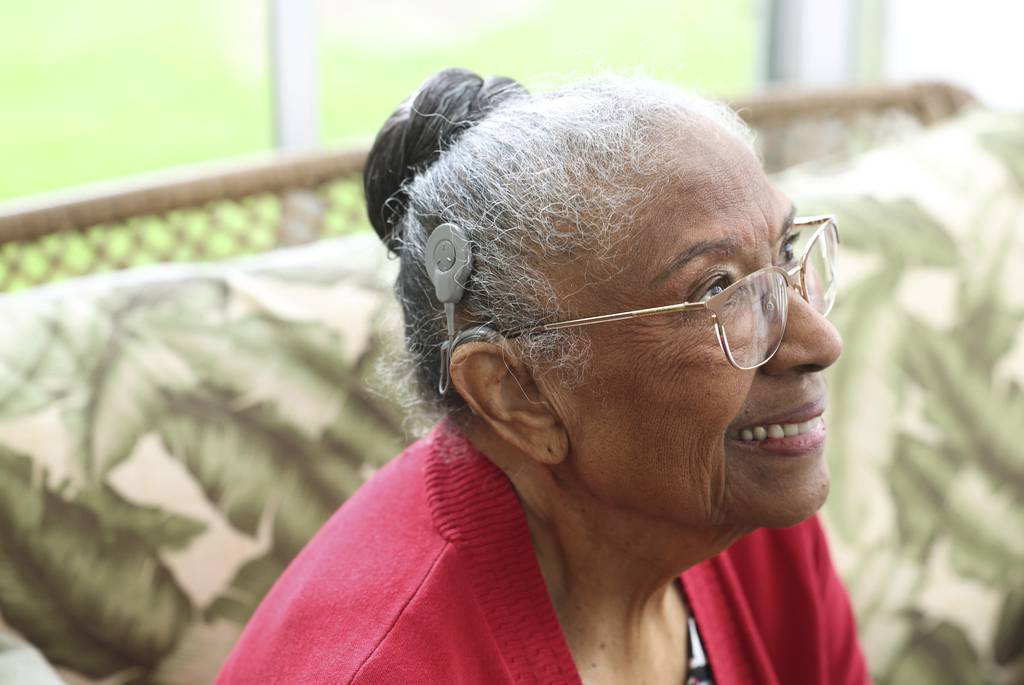 Clarice Boswell, who's retired from teaching and administration at Joliet Township High and the University of St. Francis, sits in her sunroom at home on April 25, 2023, in Plainfield. She recently received a cochlear implant. 