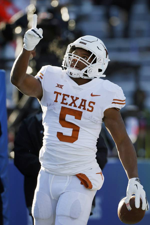 Texas running back Bijan Robinson celebrates after scoring a touchdown against Kansas on Nov. 19, 2022, in Lawrence, Kan.