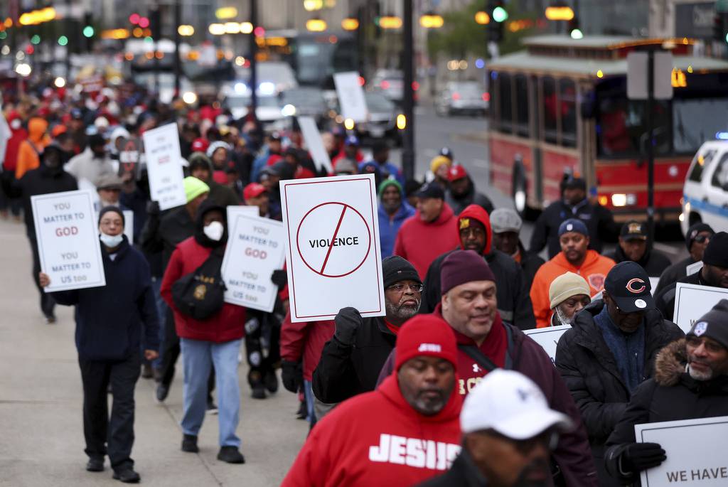 Faith leaders and others march through downtown Chicago on April 22, 2023, in response to youth violence that occurred the previous weekend. 