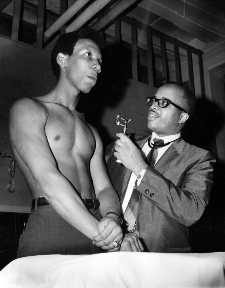 Dr. Glenn Bynum, of Chicago, gives a physical to Bob McDonald, a Catholic Youth Organization fighter from Chicago, weight 160, on Jan. 31, 1969, for an upcoming Golden Gloves fight. 