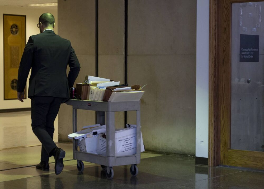 Legal files on a cart are moved toward a courtroom at the Leighton Criminal Court Building in January.