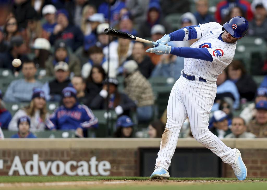 Cubs left fielder Ian Happ drives in two runs with a single in the eighth inning against the Rangers on Saturday at Wrigley Field. An extra run scored for the Cubs on the play due to an error.