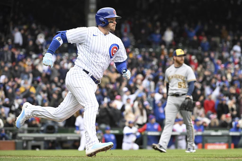 Cubs left fielder Ian Happ rounds the bases in front of Brewers pitcher Brandon Woodruff after hitting a home run in the sixth inning Saturday at Wrigley Field. The Cubs lost 3-1. 
