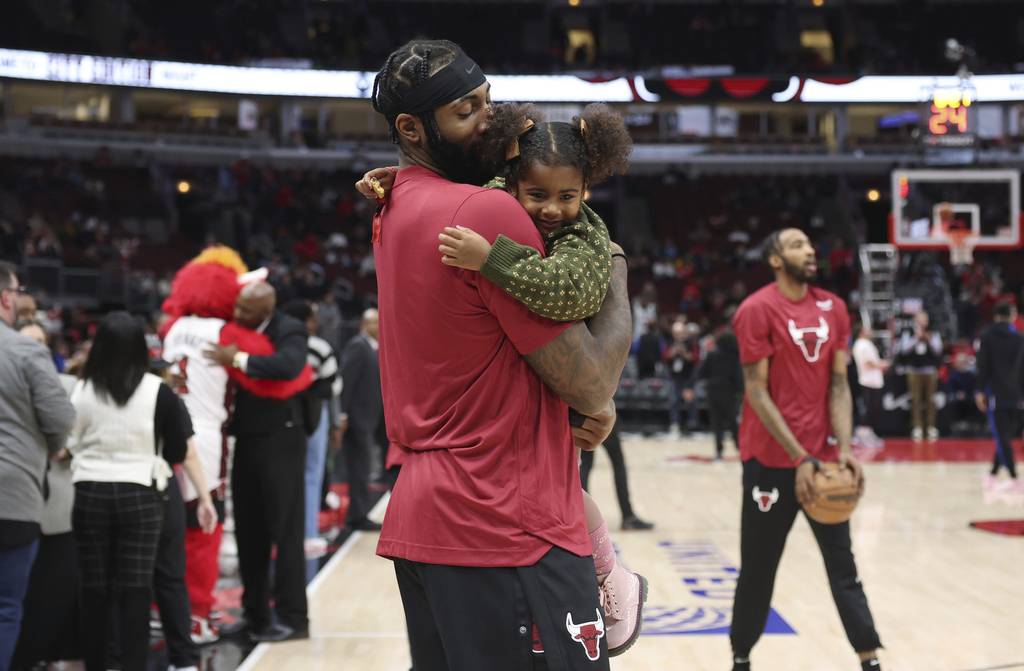 Bulls center Andre Drummond holds his 3-year-old daughter, Aubrey, during warmups for a game against the Magic at the United Center Nov. 18, 2022.