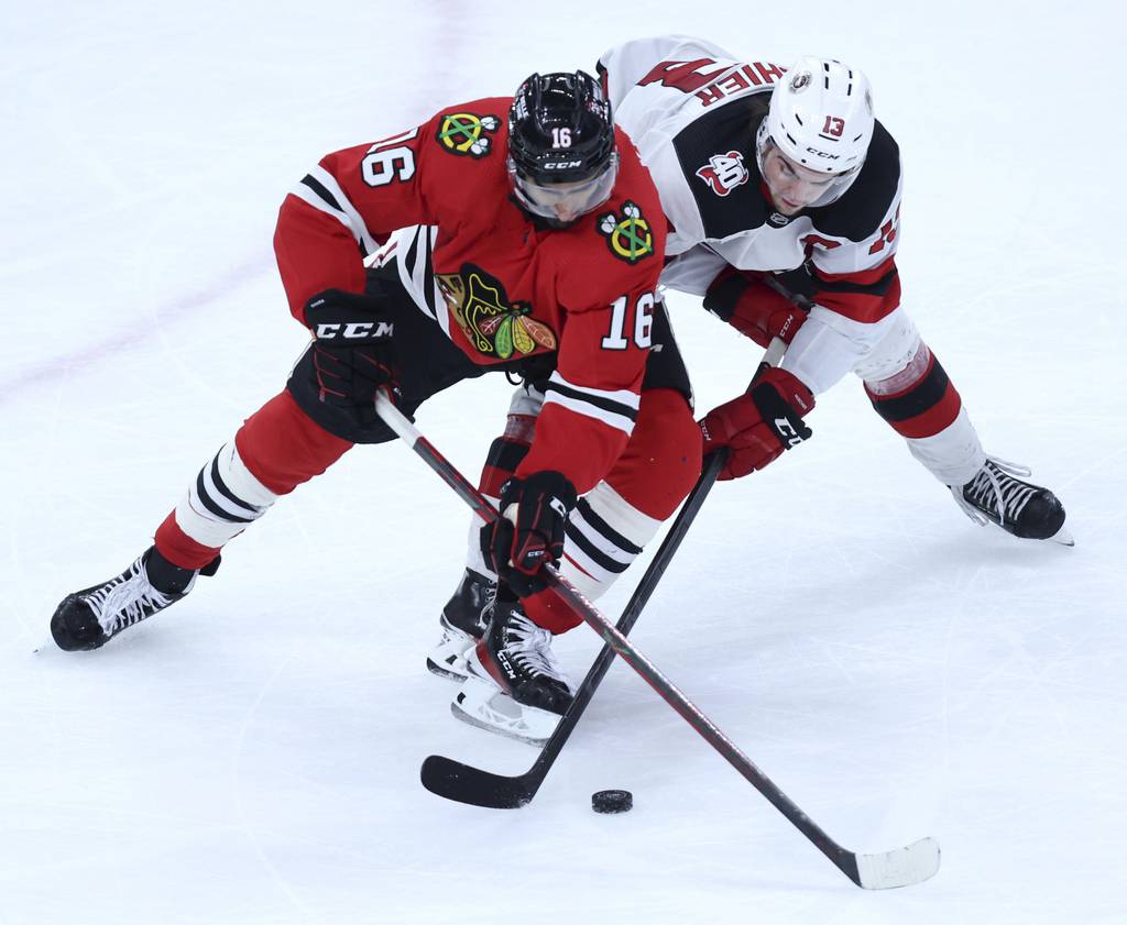 Blackhawks left wing Jujhar Khaira (16) and Devils center Nico Hischier battle in the third period on April 1 the United Center. 