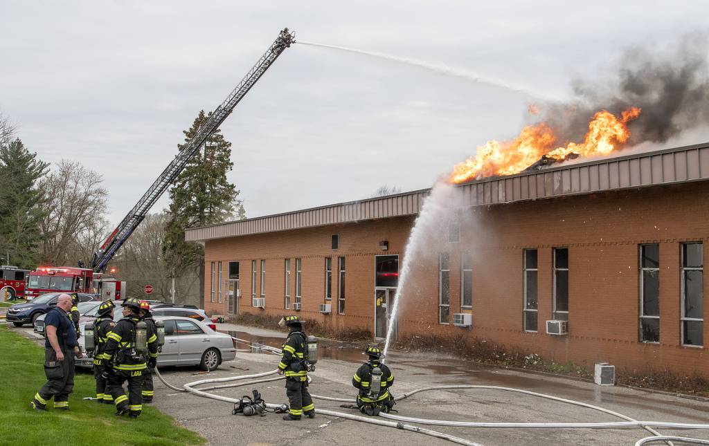 Firefighters battle a blaze from the ground and from a ladder truck at the Art-Psychology Building on the campus of Valparaiso University in Valparaiso, Indiana Friday April 29, 2022. (Andy Lavalley for the Post-Tribune)