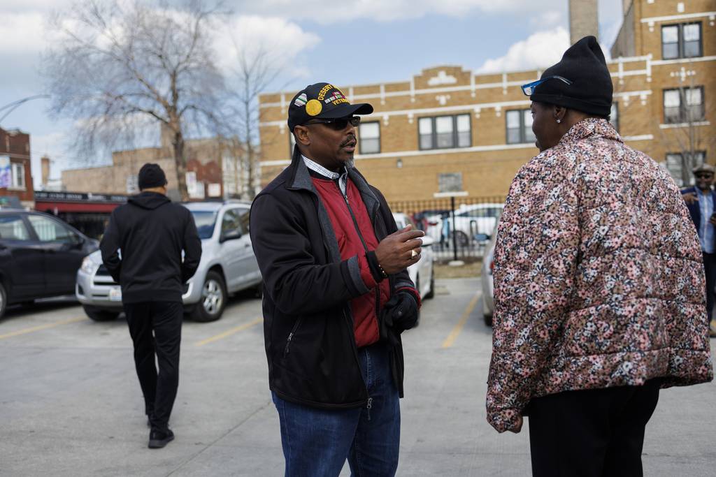 Aldermanic candidate Richard Wooten, center, talks with Deborah Echols-Moore outside the Whitney M. Young, Jr. branch of the Chicago Public Library on March 28, 2023, in Chicago. 