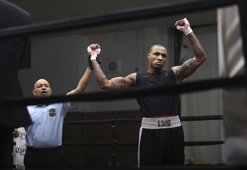 Super heavyweight boxer Eric Ross is declared the winner after knocking out opponent Andres Merlos.
