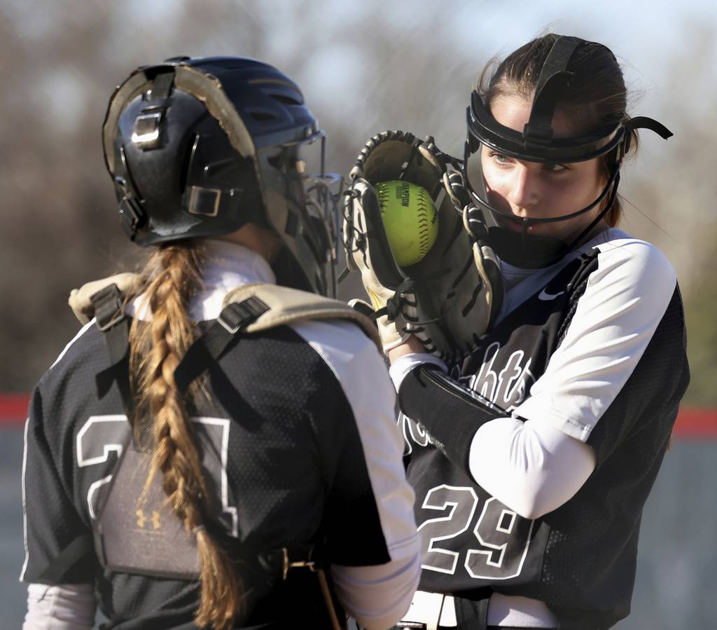 Kaneland catcher MacKenzie Hardy (24) and pitcher Brynn Woods (29) talk things over against West Aurora during a nonconference game in Aurora on Thursday, April 6, 2023.