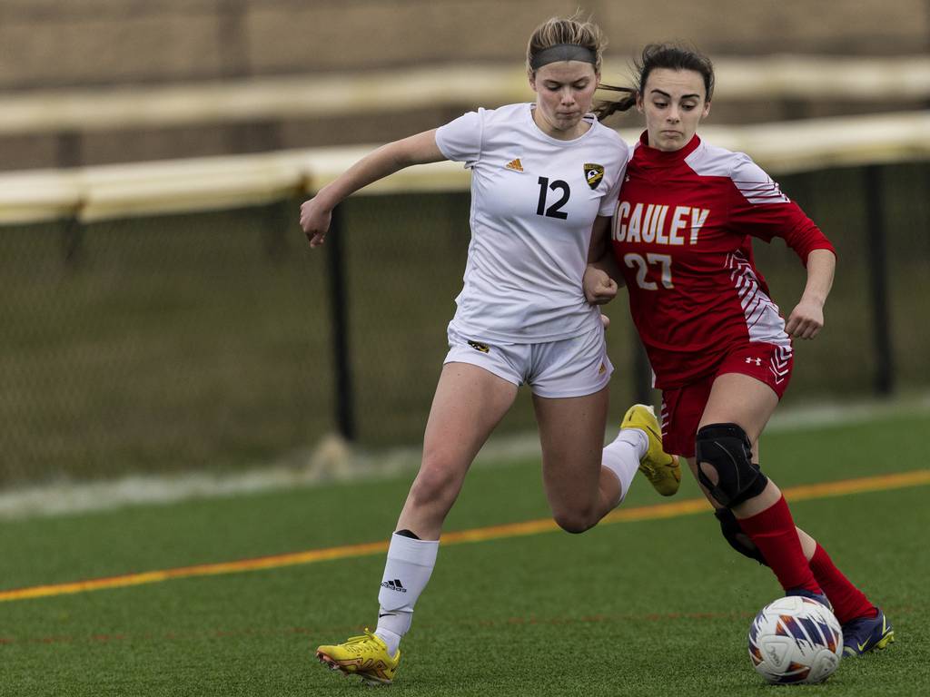 Andrew’s Grace Wood (12) advances a ball as Mother McAuley's Zoey Martin (27) tries to win control during a nonconference game in Chicago on Monday, April 3, 2023.
