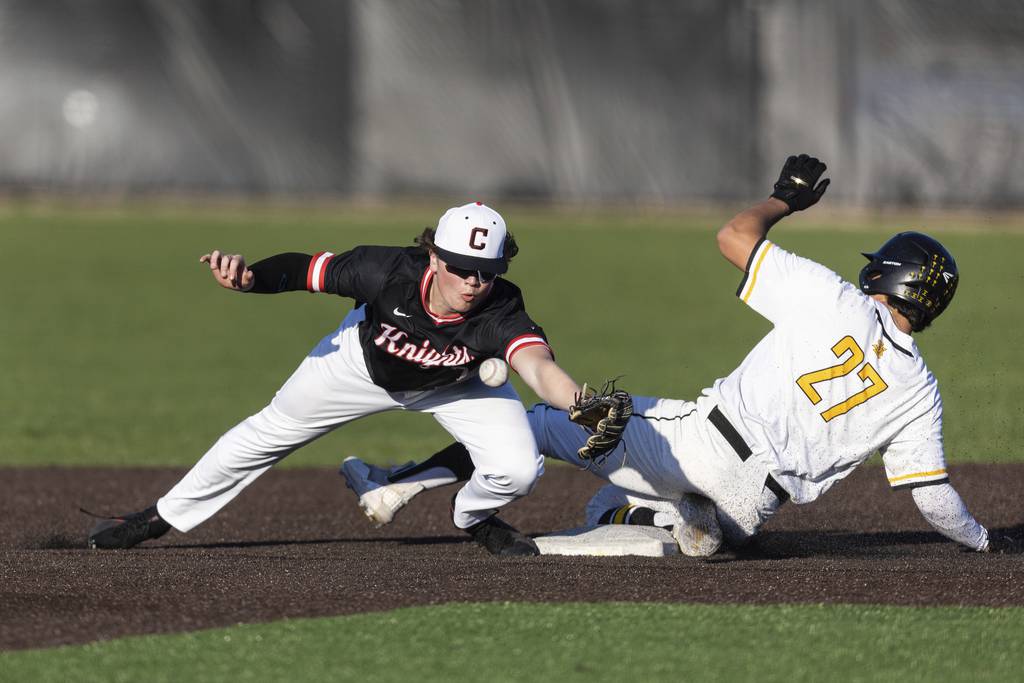 St. Laurence's Michael Carrano (27) slides into second base as Lincoln-Way Central's Charles Cismoski (7) stretches for the throw during a nonconference game in Burbank on Wednesday, April 12, 2023.