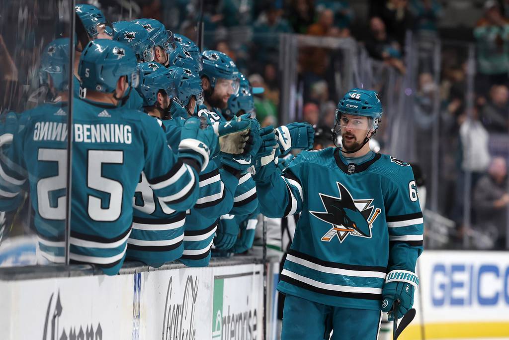 The Sharks' Erik Karlsson is congratulated by teammates after he scored a goal against the Stars in the third period on Jan. 18, 2023.