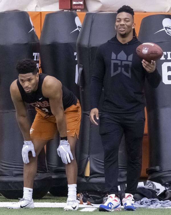 Texas running back Bijan Robinson, right, talks with former teammate Roschon Johnson as players prepare to work out for NFL scouts during Texas pro day on March 9, 2023, in Austin, Texas.