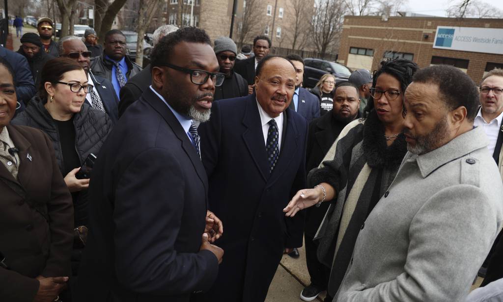 Martin Luther King III, center, greets faith and labor leaders following a press conference endorsing mayoral candidate Brandon Johnson, second from left, on Friday.