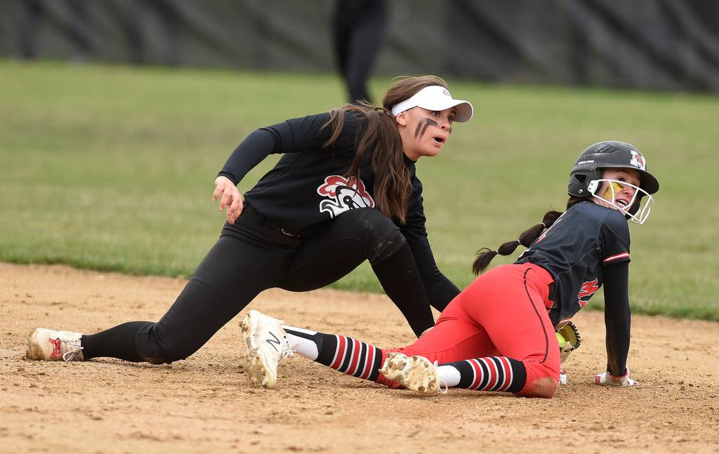 Lincoln-Way Central shortstop Alexis Youngren (11) puts the tag down on Marist's Sierra Sass (1) during a nonconference game in Chicago on Monday, April 4, 2022.
