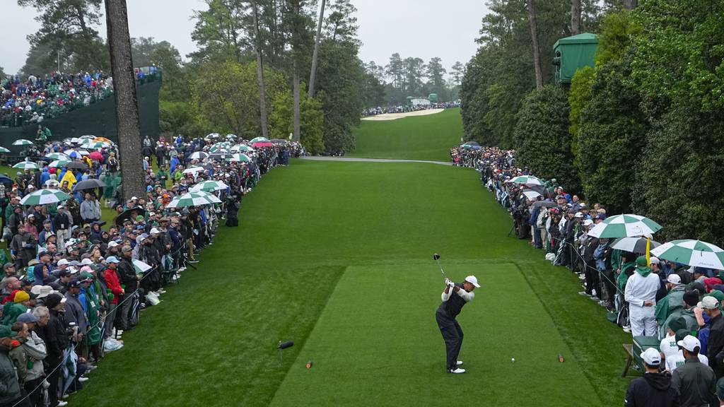 Tiger Woods hits his tee shot on the 18th hole during the weather-delayed second round of the Masters on Saturday at Augusta National Golf Club in Augusta, Ga. 