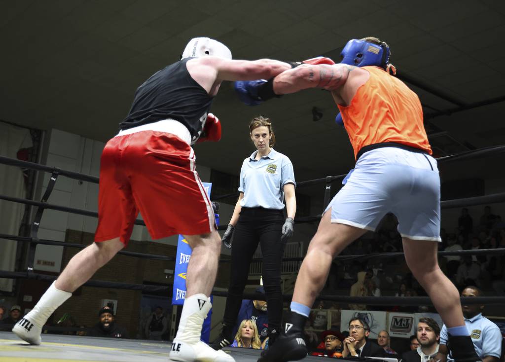 Boxing referee Kim Carlson officiates a semifinal bout between super heavyweights T.J. Hofland and Aidan Sullivan at the Chicago Golden Gloves on March 25, 2023, in Cicero.  