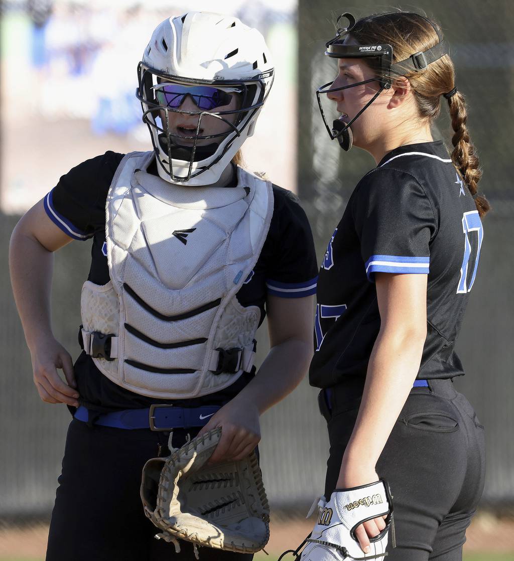 St. Charles North' catcher Sophia Olman and pitcher Ava Goettel (17) talk things over against Lincoln-Way East during a nonconference game on Wednesday, April 12, 2023.