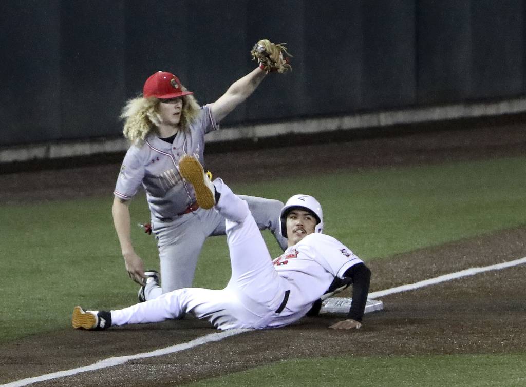 Bremen's Xavier Aguilar gets tagged out at third base by Tinley Park's Michael Vesely during a South Suburban Blue game at Ozinga Field in Crestwood on Friday, April 29, 2022.