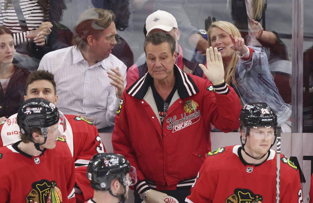 Mike Gapski, center, is congratulated on his final day as Blackhawks trainer in the first period against the Flyers on Thursday at the United Center. 