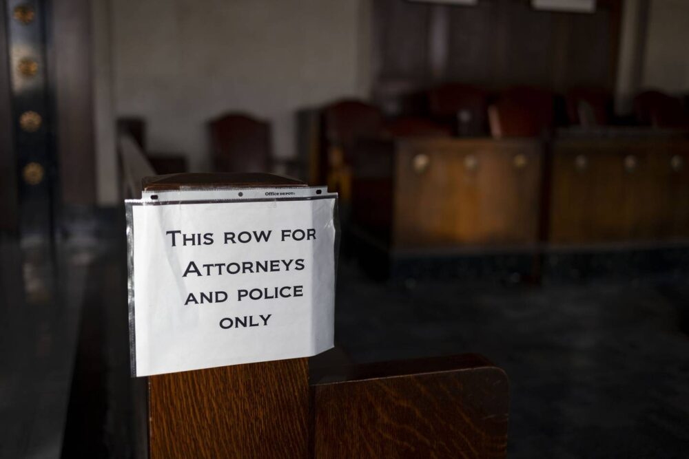 A sign in Courtroom 700 at the Leighton Criminal Court Building. The testimony of police officers is key at certain points in a criminal case.