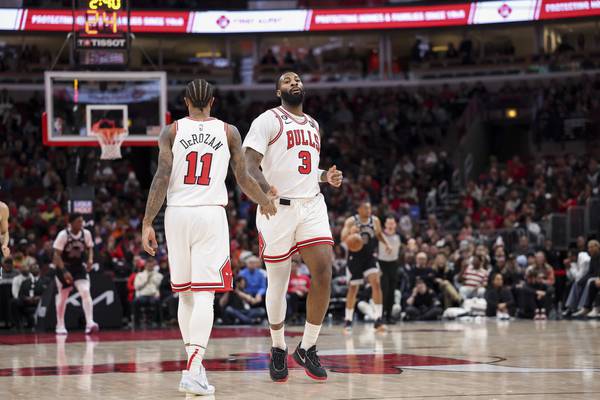 Bulls center Andre Drummond high-fives forward DeMar DeRozan (11) during the third quarter against the Spurs at the United Center on Feb. 6, 2023.