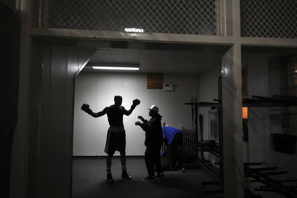Super heavyweight Eric Ross warms up with coach Rodney Wilson before a preliminary fight at the Chicago Golden Gloves boxing tournament at Cicero Stadium on March 10, 2023.  