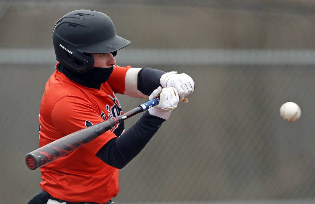 St. Charles East's Seth Winkler (15) follows through on a hit against Waubonsie Valley during a nonconference game in Aurora on Tuesday, March 29, 2022.