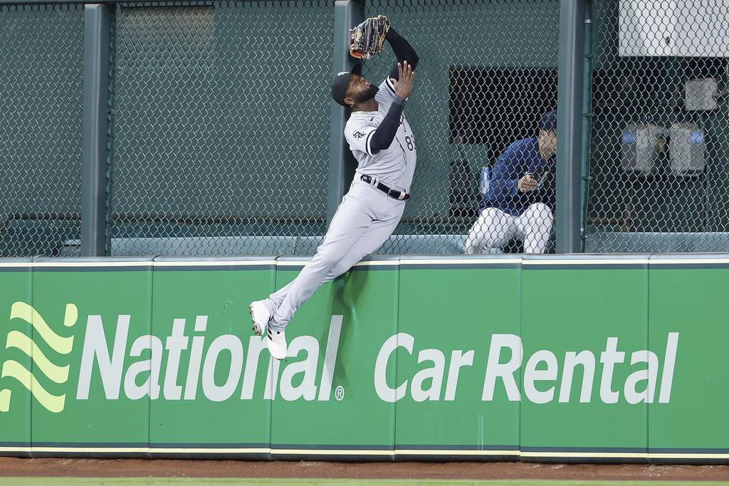 White Sox center fielder Luis Robert Jr. makes a leaping catch at the wall on a ball hit from the Astros' Kyle Tucker in the third inning Saturday at Minute Maid Park in Houston. 