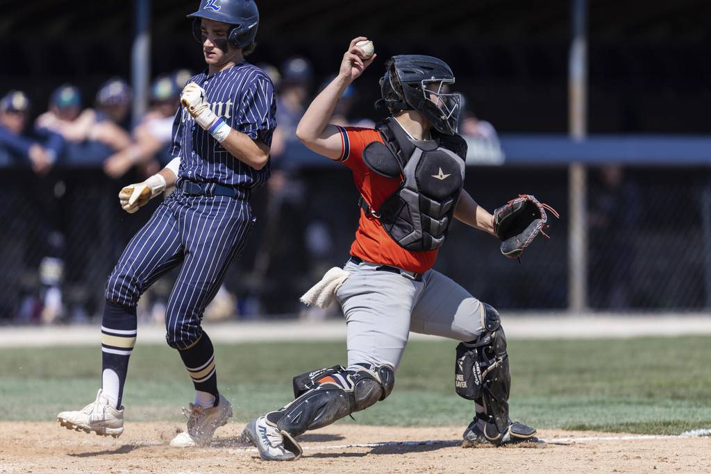 Stagg catcher Aiden Taylor (10) tags home before throwing to third to complete a double play against Lemont during a nonconference game in Lemont on Saturday, April 8, 2023.