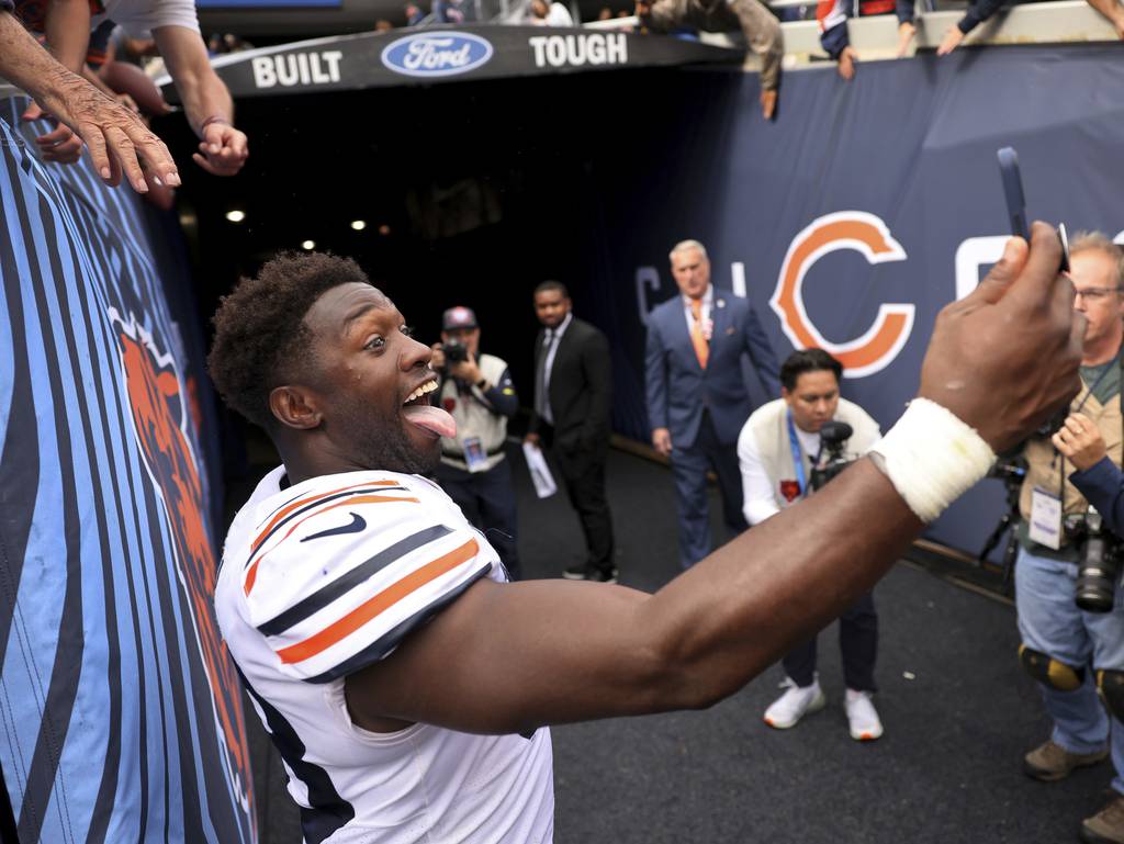 Bears linebacker Roquan Smith takes a selfie with fans after a victory against the Texans on Sept. 25 at Soldier Field.