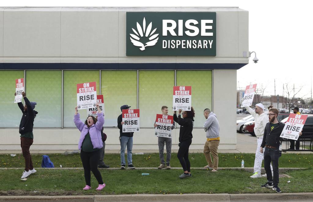 Rise Dispensary employees picket outside their workplace, April 19, 2023, in Niles. Employees at three Rise locations, including two in Joliet, went on an open-ended unfair labor practice strike to demand better wages and retirement contributions.  