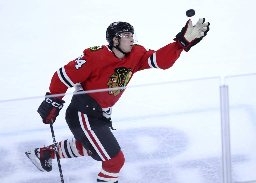 Blackhawks defenseman Wyatt Kaiser catches an airborne puck in the third period against the Devils on April 1 at the United Center. 
