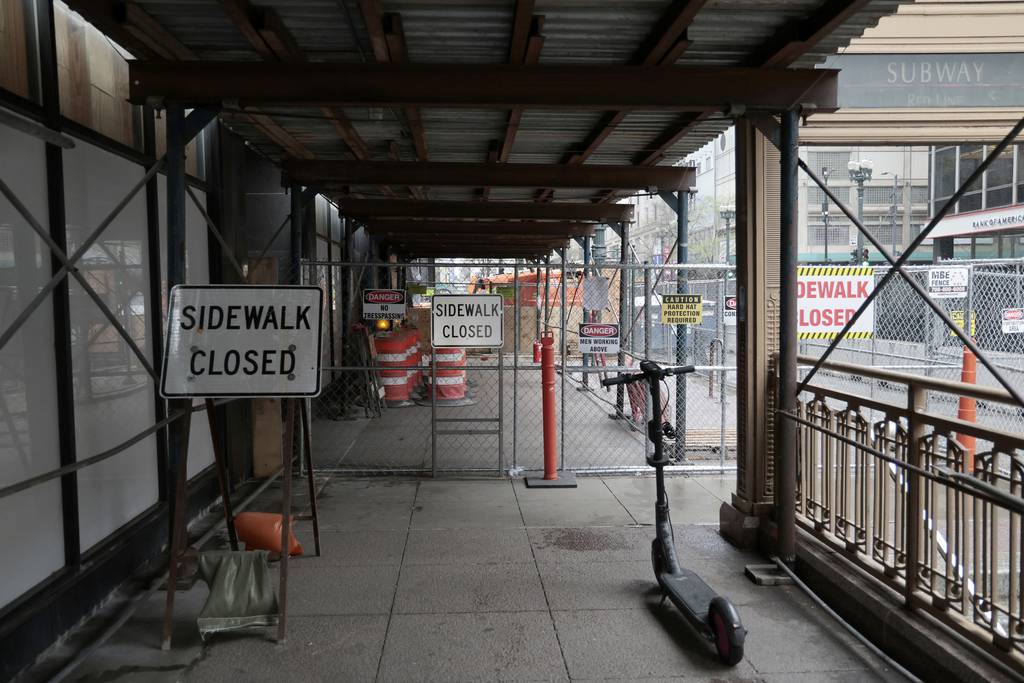 Fencing blocks the sidewalks in front of the Consumers Building, 220 S. State St., and the Century Building, 202 S. State St., on April 17, 2023.