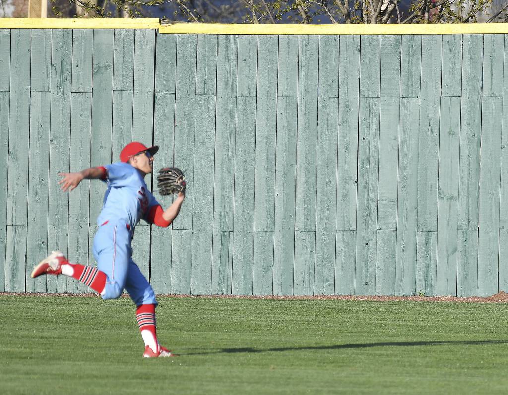 St. Rita center fielder Tommy Atkinson grabs a fly ball on the run off the bat of his brother Sammy, who plays for Providence, during a Catholic League Blue game in New Lenox on Tuesday, April 18, 2023.