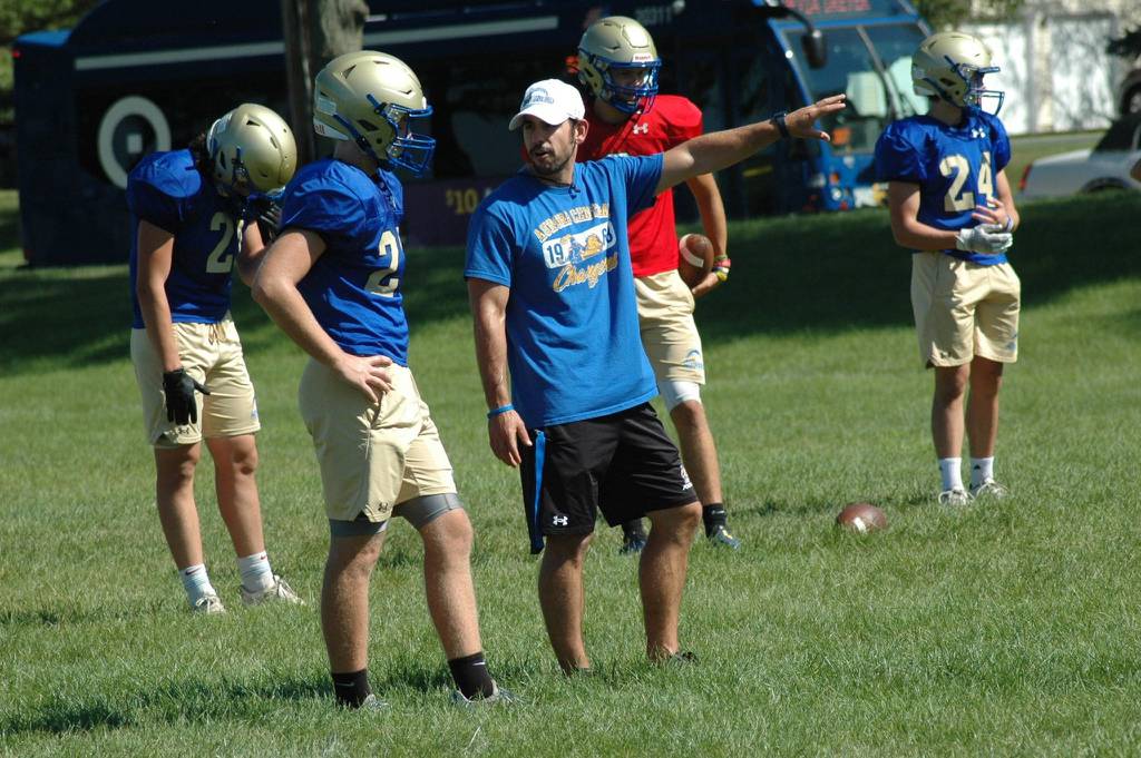 Aurora Central Catholic coach Christian Rago gives a player directions during a preseason practice on Thursday, Aug. 11, 2022.
