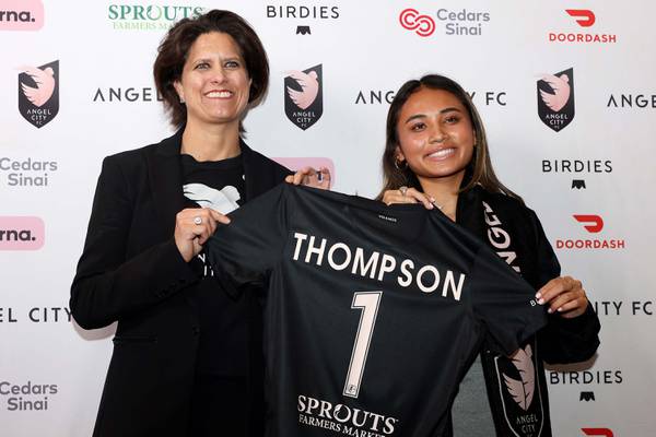 First overall draft pick Alyssa Thompson and Angel City Football Club President Julie Uhrman  pose with a jersey during a draft watch party on Jan. 12, 2023, in Los Angeles.