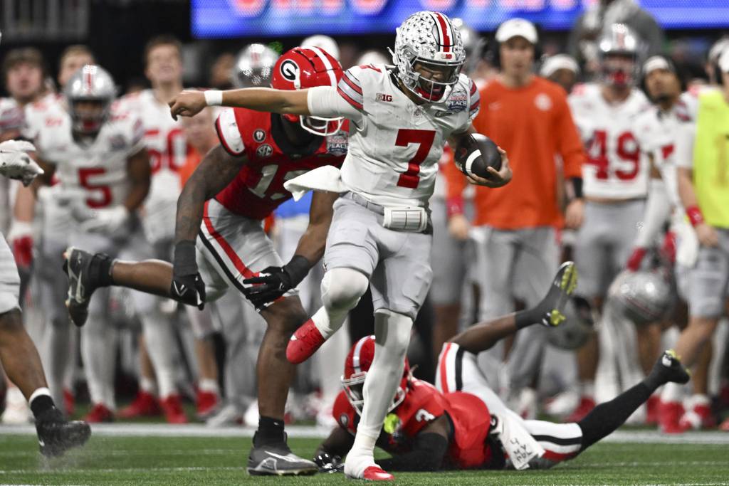 Ohio State quarterback C.J. Stroud runs against Georgia during the second half of the Peach Bowl on Dec. 31, 2022.