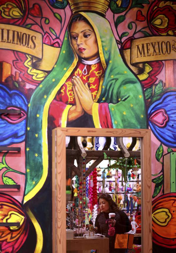 Andrea Perez, of San Antonio, is reflected in a mirror while shopping at Colores Mexicanos on April 21, 2023.  