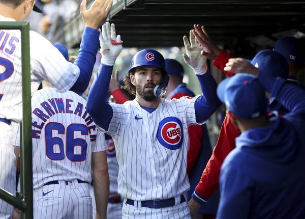 Cubs shortstop Dansby Swanson is congratulated by teammates in the dugout after hitting a two-run home run in the third inning against the Cardinals on Tuesday at Wrigley Field.