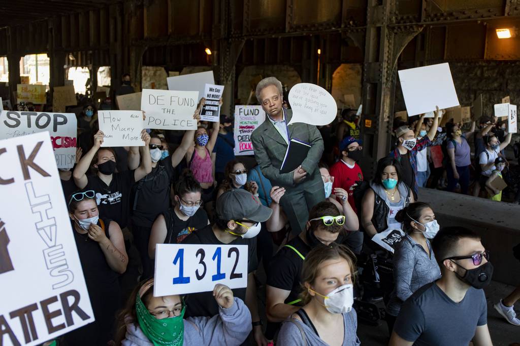 Protesters carry a cutout of Mayor Lori Lightfoot while demonstrating on Ashland Avenue during a march for justice from Union Park to Cabrini-Green on June 6, 2020, to demand police accountability. 